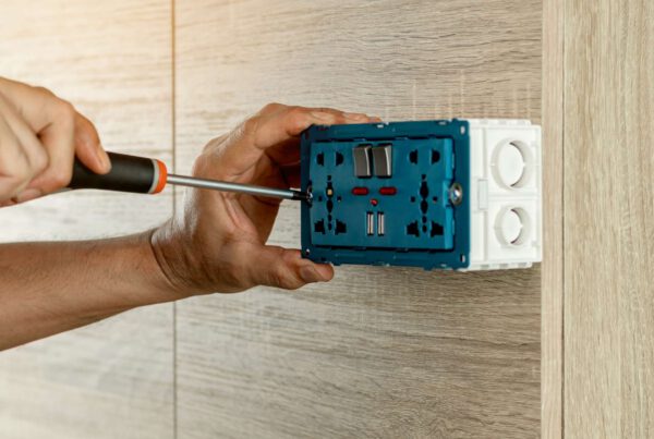 okc handyman working on an outlet